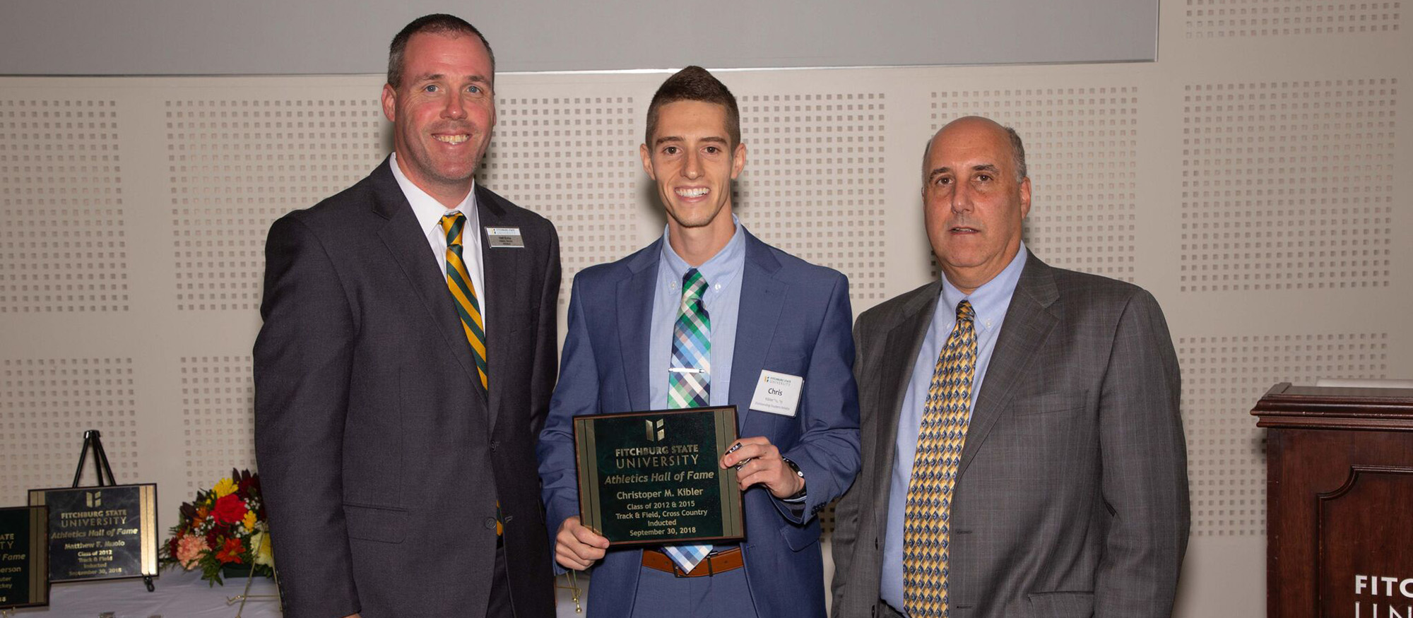 MHC head cross country and track & field coach, Chris Kibler is pictured with representatives from Fitchburg State during his induction into the Fitchburg State Athletics Hall of Fame.