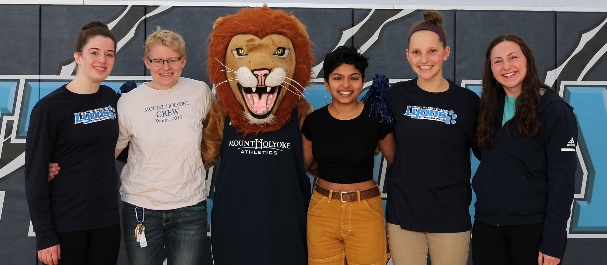 Members of the Lyons Student-Athlete Advisory Committee, along with the MHC Athletics mascot Paws, pose for a photo celebrating National Girls and Women in Sports Day.