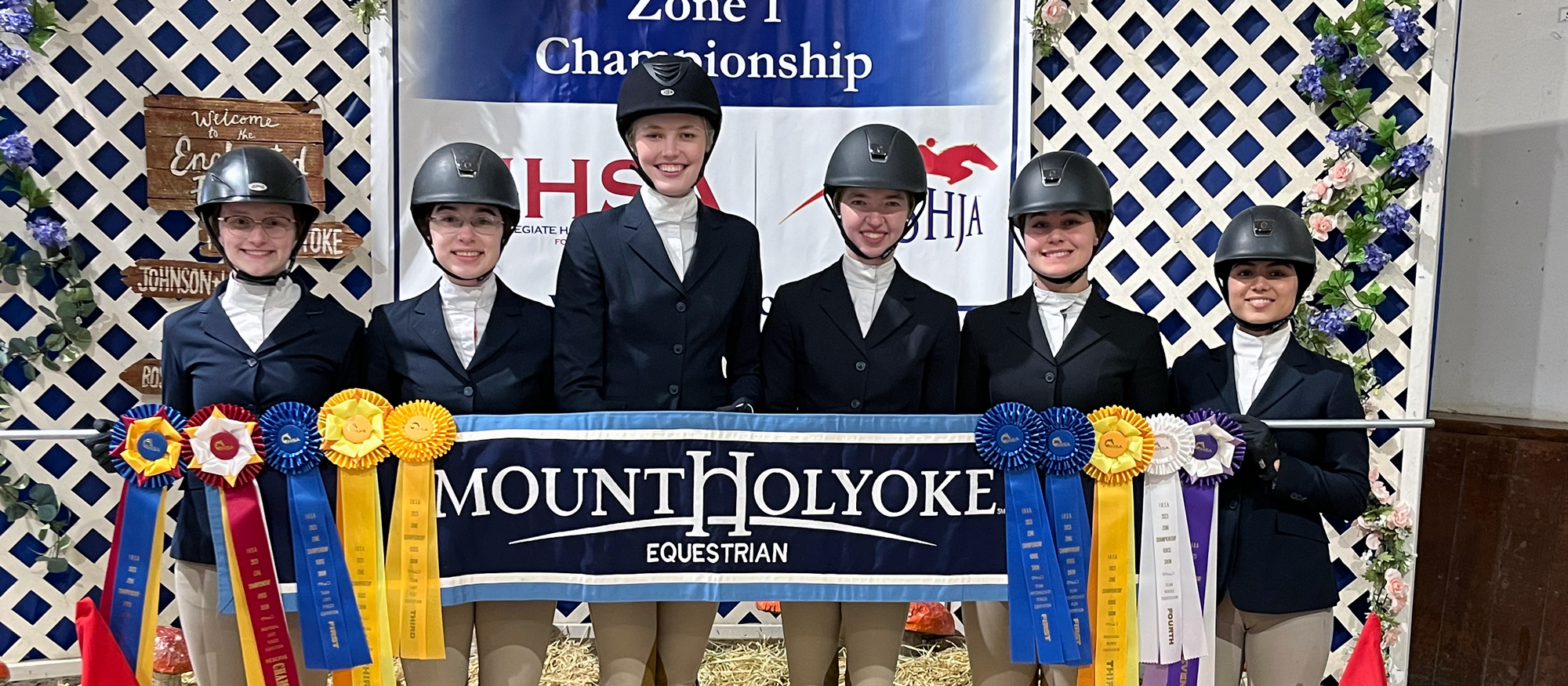 From left to right, Cate Bates, Johanna Sullivan, Chloe McElveen, Emmie Mirarchi, Madison Hurley, and Sunita Pearson-Siegel display their ribbons won on the first day of the IHSA Zone 1 Championships.
