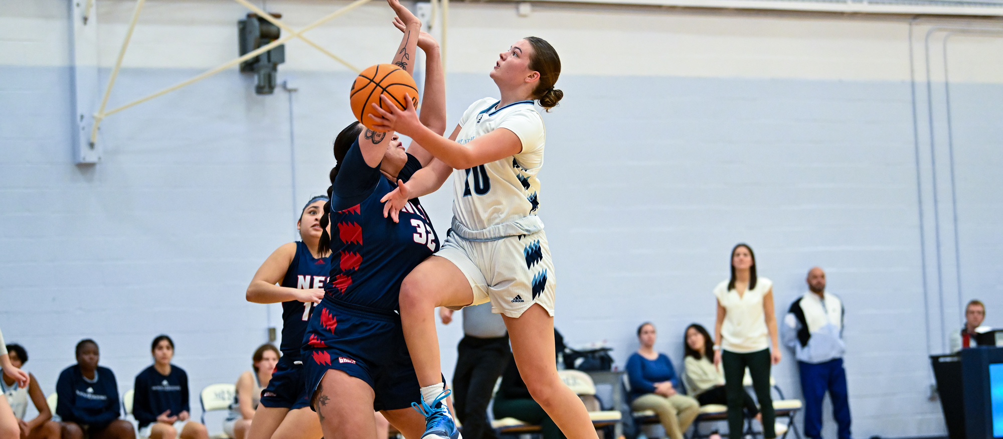 Emma Goff drives for a layup in Mount Holyoke's 54-45 loss to New England College on Nov. 15, 2023. Goff led the Lyons with 13 points and eight rebounds. (Bob Blanchard/RJB Sports)
