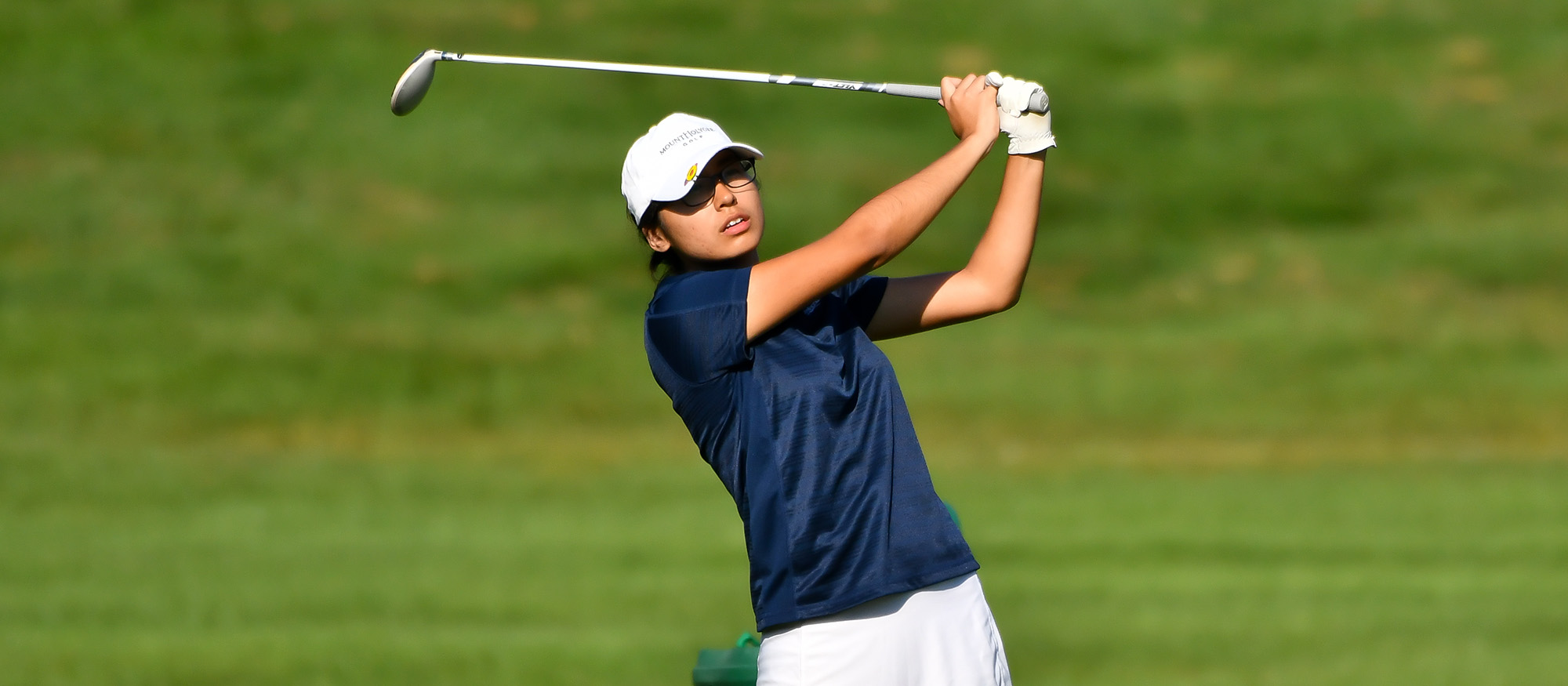 Action photo of Lyons golf student-athlete, Lahela Delaney.