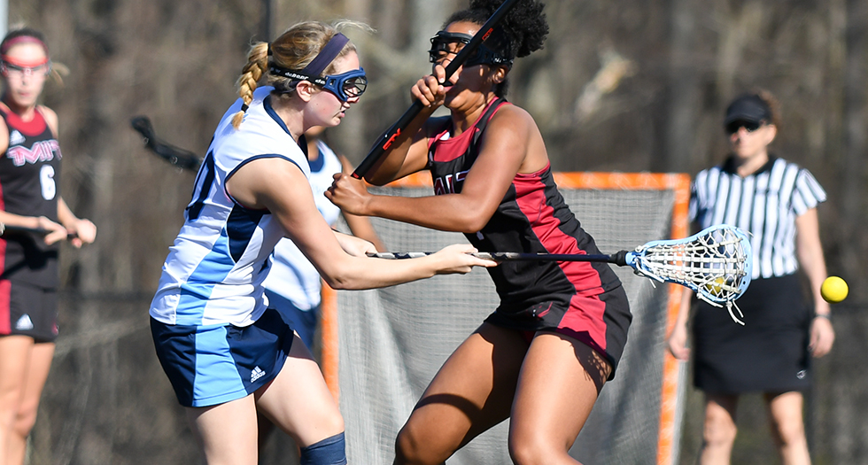 Mary LaVigne '20 (left) scores against MIT in the first half on Friday.