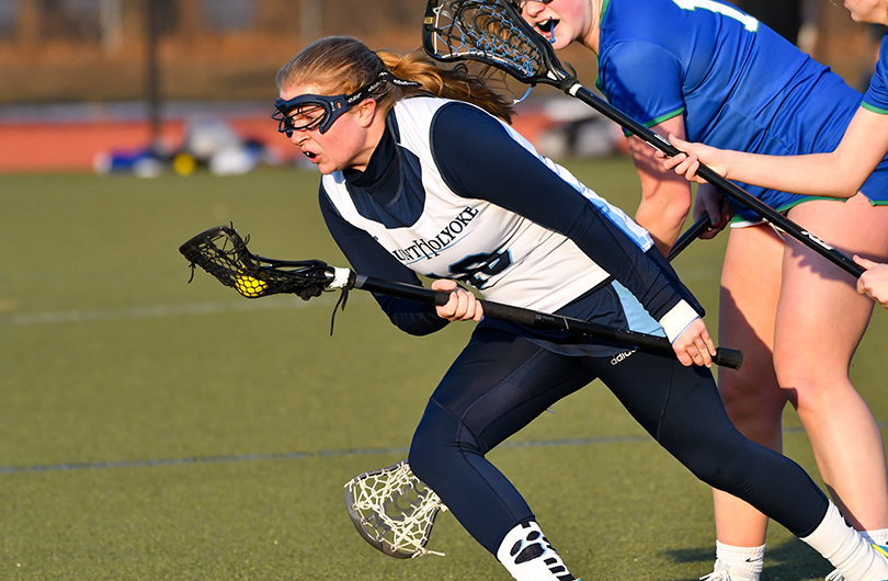 Action photo of Lyons lacrosse player, Morgan Tanguay.