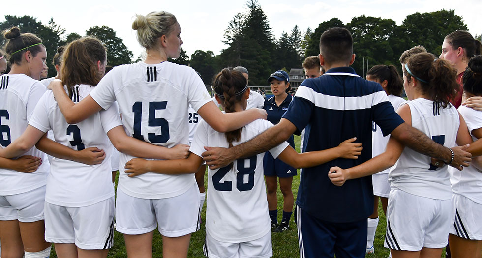 Members of the 2016 Mount Holyoke soccer team in a pregame huddle.