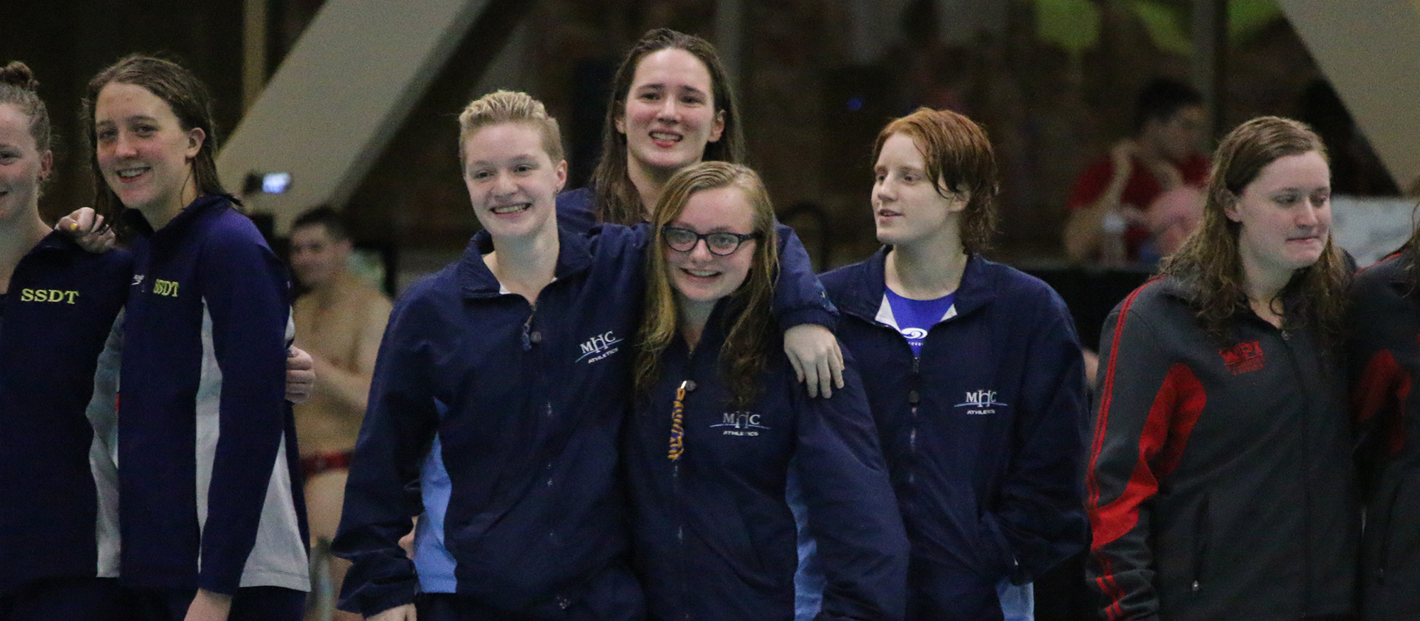 Photo showing the Lyons swimming & diving 800-freestyle relay team from the first night of action at the NEWMAC Championships. Left to right: Claire Beckett, Naomi Brown, Ashton Bliss and Bri Groves.