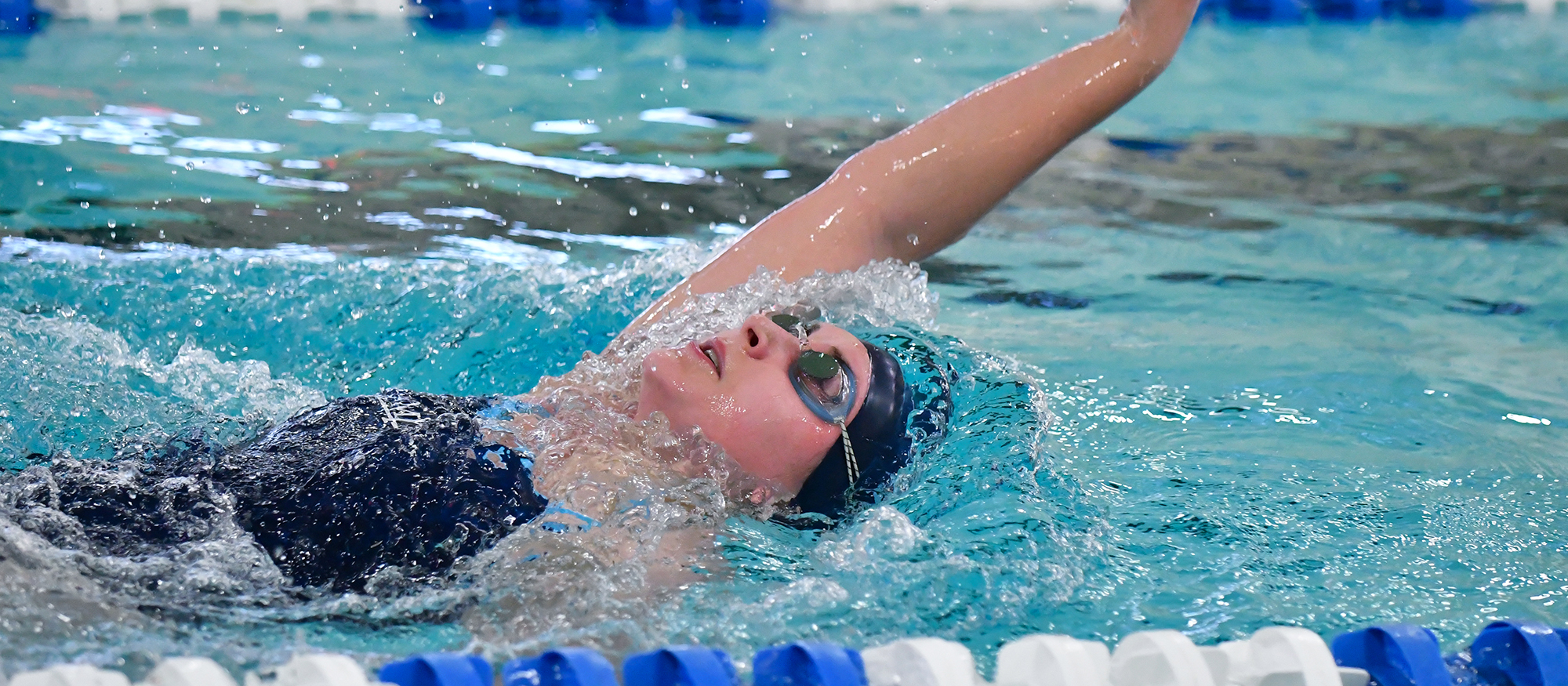 Action photo of a Lyons swimmer during the 2017 home meet against Wellesley.