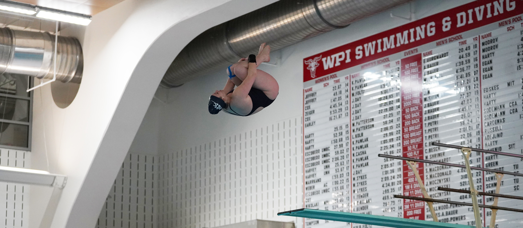 Maddy Sewell dives off the 3-meter board en route to second place at the NEWMAC Swimming and Diving Championships on Feb. 17, 2023. (Alex Gutierrez/WPI Athletics)