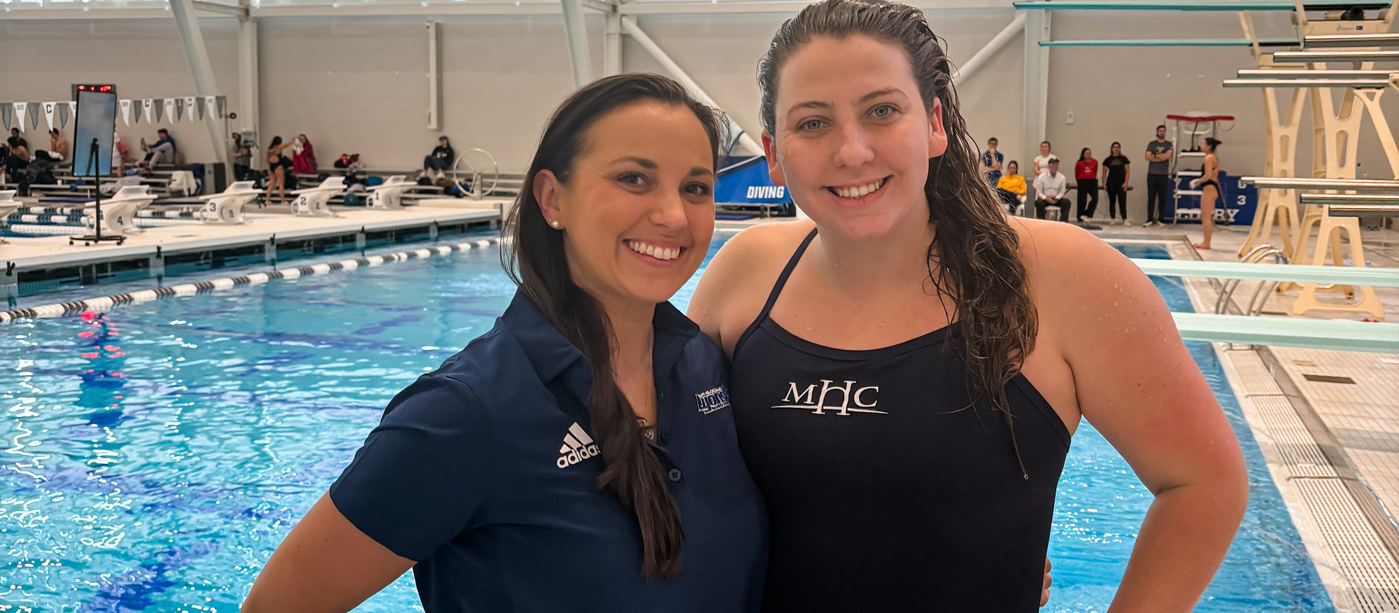 Senior diver Maddy Sewell with Mount Holyoke diving coach Rachael Araujo at NCAA Diving Regionals at Colby College.