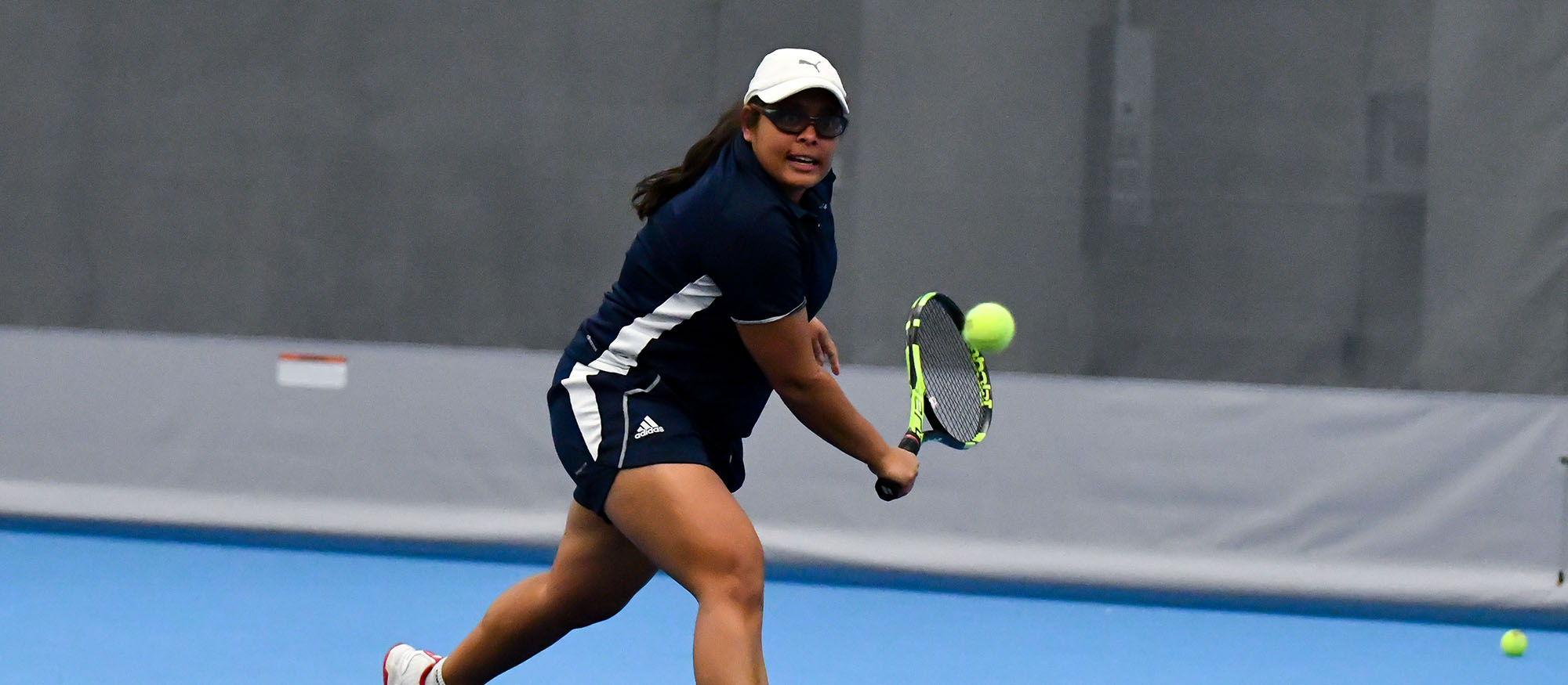 Action photo of senior tennis player Ishita Tibrewal.