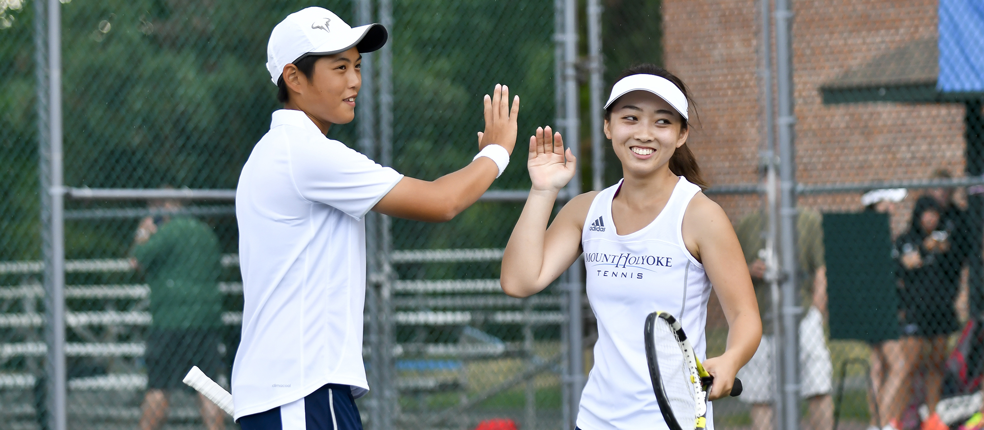 Action photo of Lyons tennis players Ching-Ching Huang (left) and Ayame Yazawa (right).