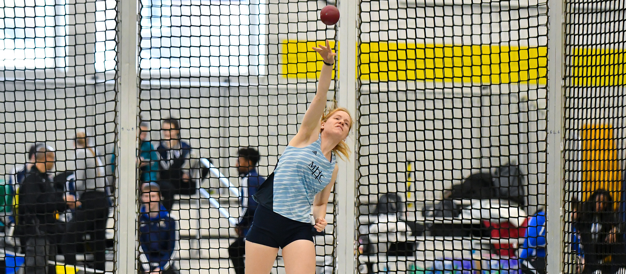 Action photo of Lyons track & field student-athlete, Charleen Theroux competing in the shot put event.