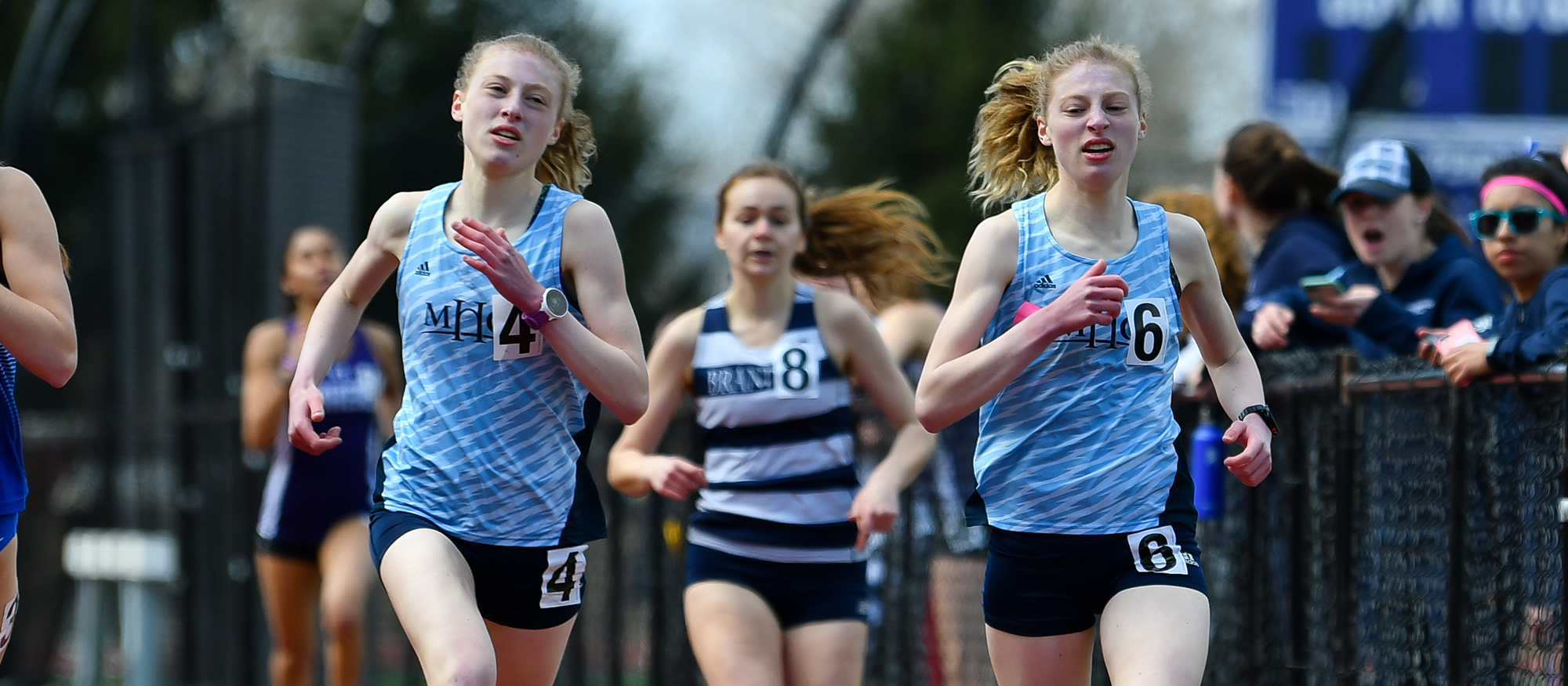 Action photo of Lyons track & field athletes, Hannah and Madeline Rieders.