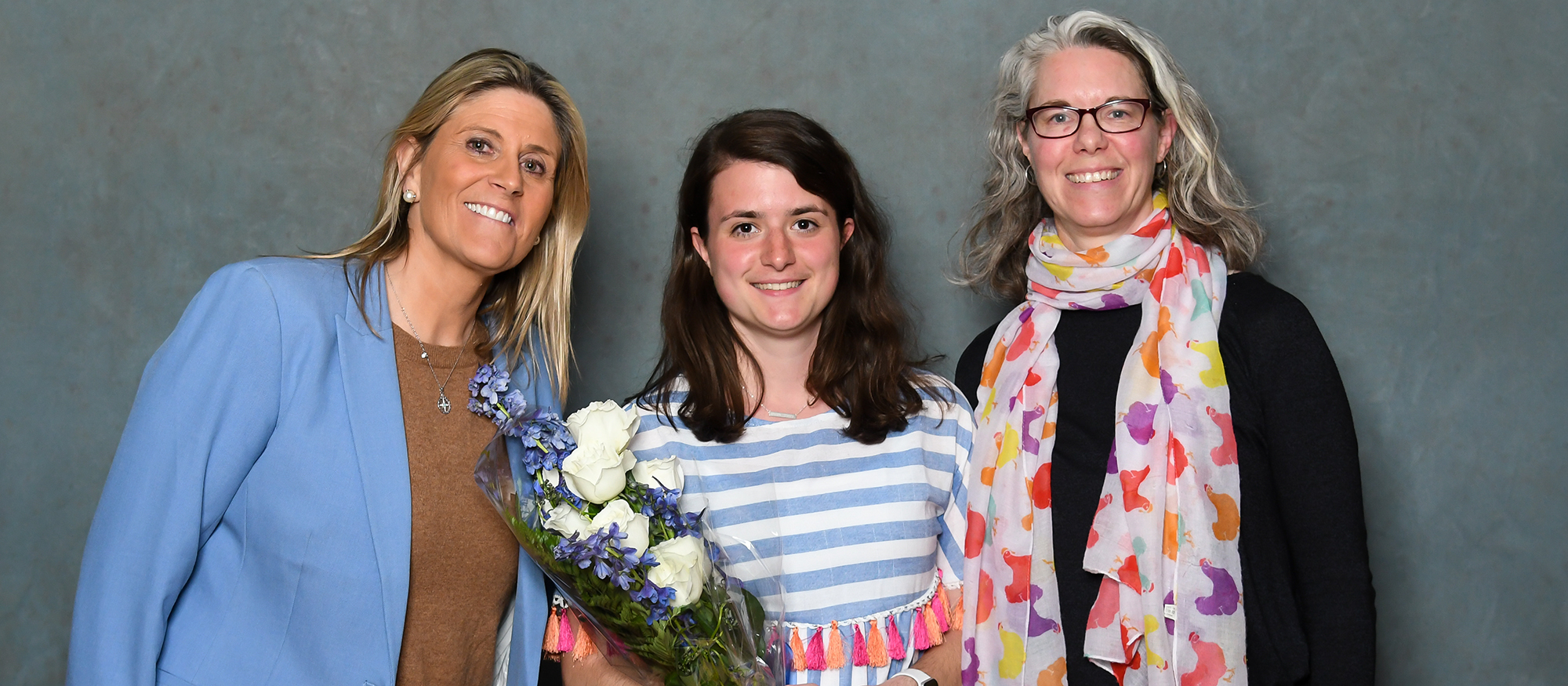 2019 Laurie Priest Alumnae Association Scholar Athlete recipient, senior field hockey captain Mirjam Keochakian (center), with head coach Andy Whitcomb (left) and Jen Grow '94, from the MHC Alumnae Association (right).