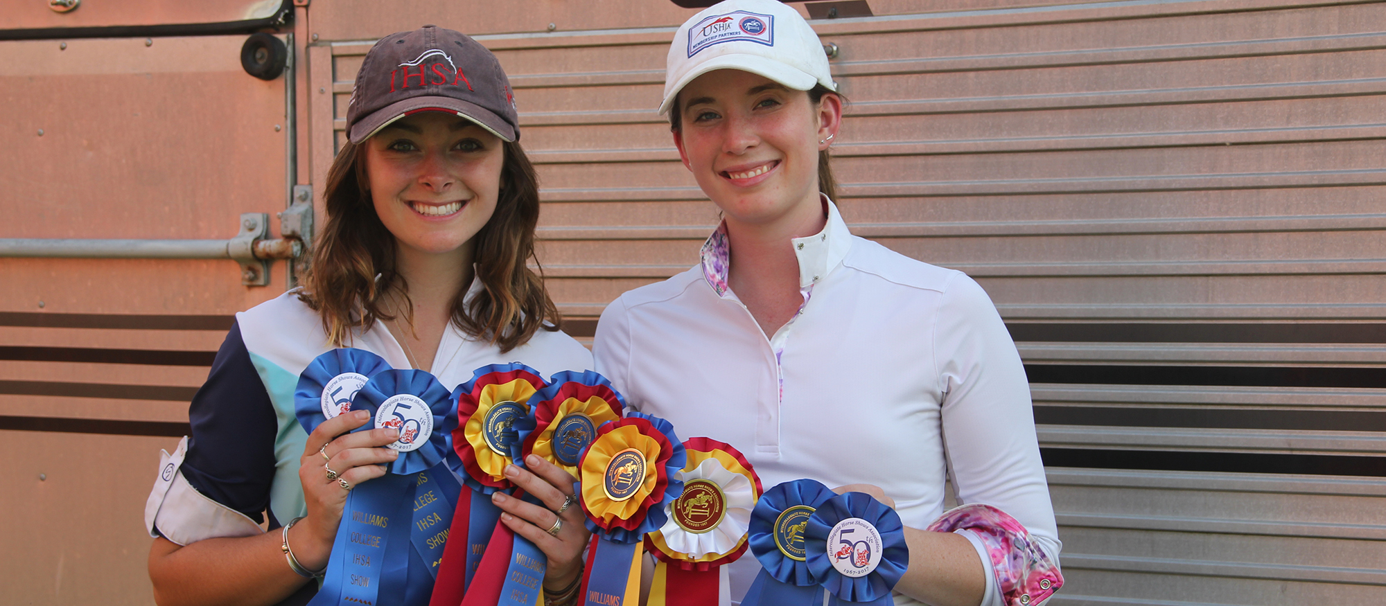Photo of Lyons riders Sabrina Fox and Anna Rzchowski  displaying their ribbons from MHC's win at the Williams Show on October 14, 2017.