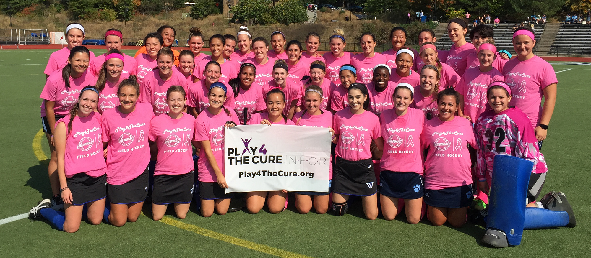 Group photo of the  Mount Holyoke and Wellesley Field Hockey teams prior to October 7th's NEWMAC Play 4 the Cure Game.