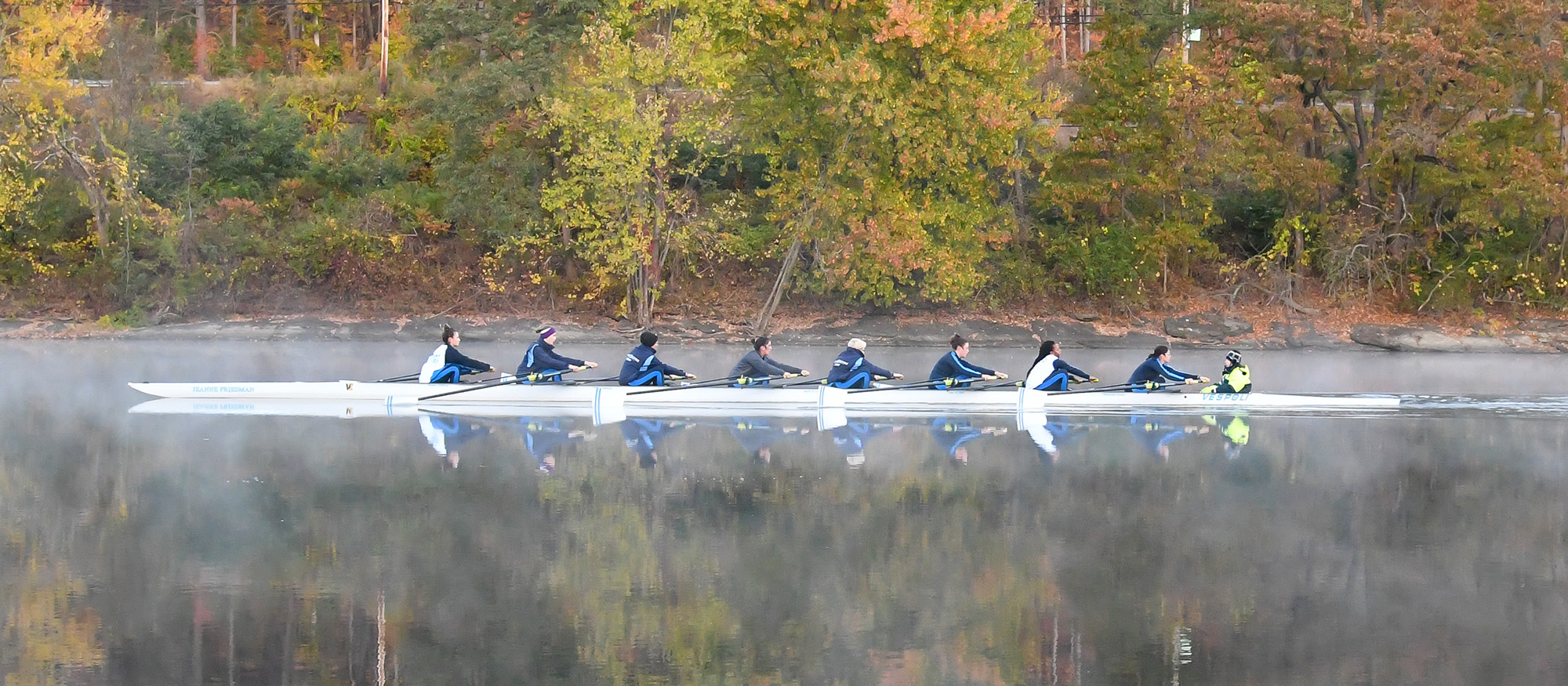 Action photo of the Lyons varsity eight boat on the Connecticut River.