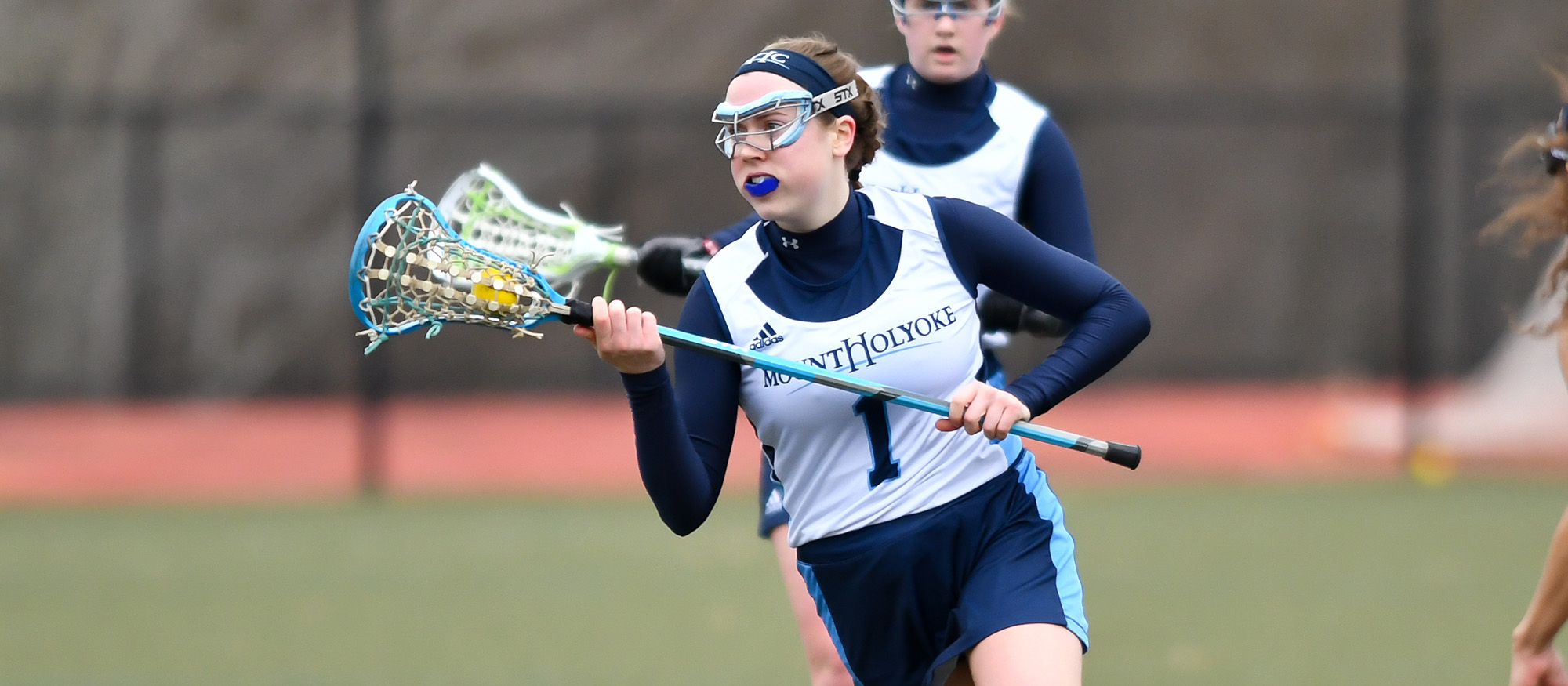 Action photo of Lyons lacrosse player, Meryl Phair.