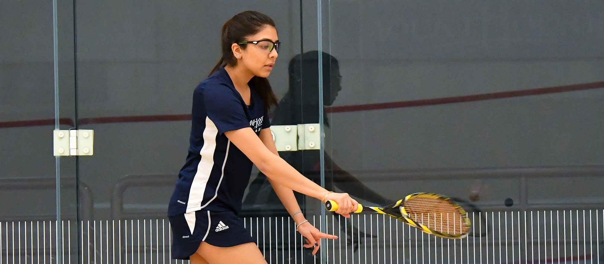 Action photo of Lyons squash player, Ragini Ghose.