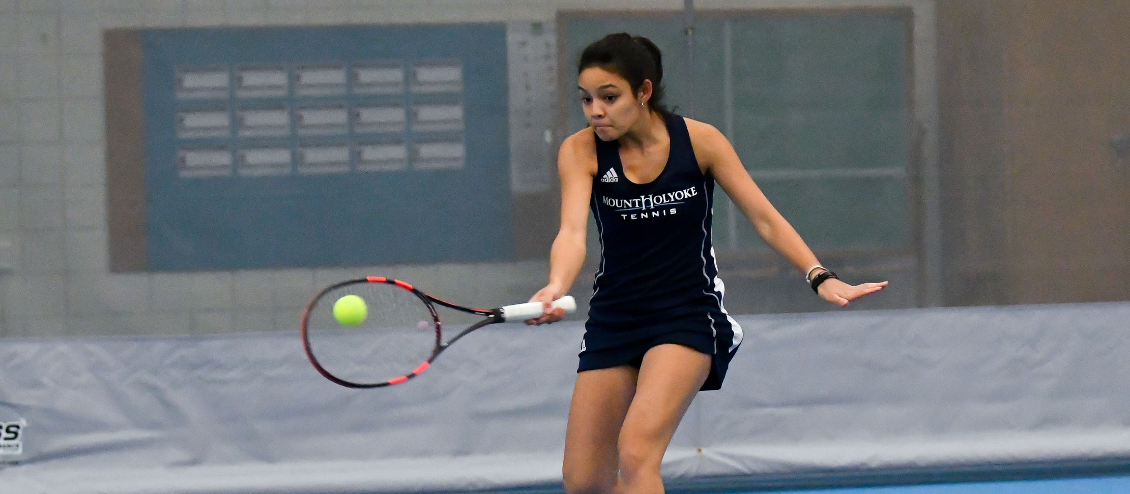 Action photo of sophomore tennis player Catherine Peabody.