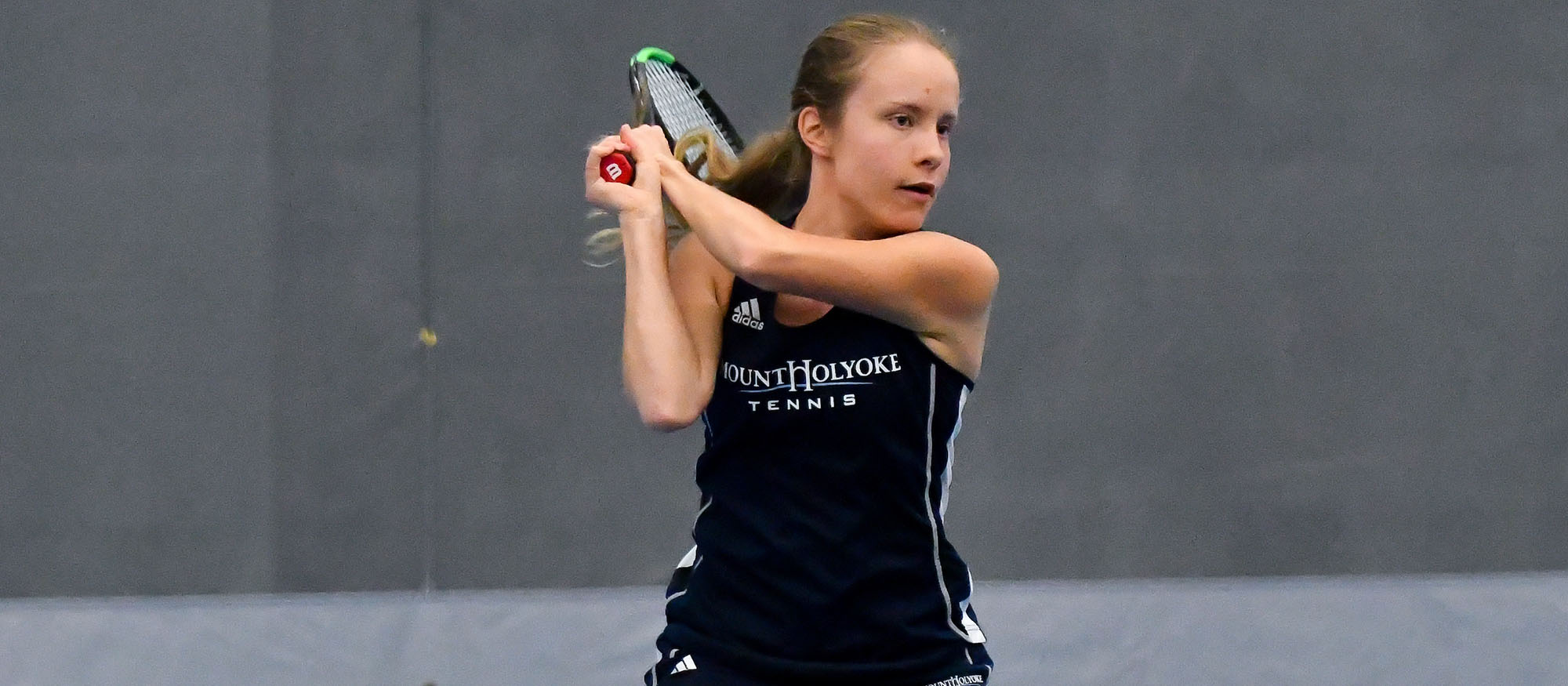 Action photo of Lyons tennis player, Anya Gerasimova.