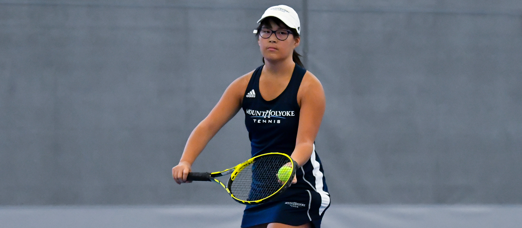 Action photo of Lyons tennis player, Hannah Middleton.