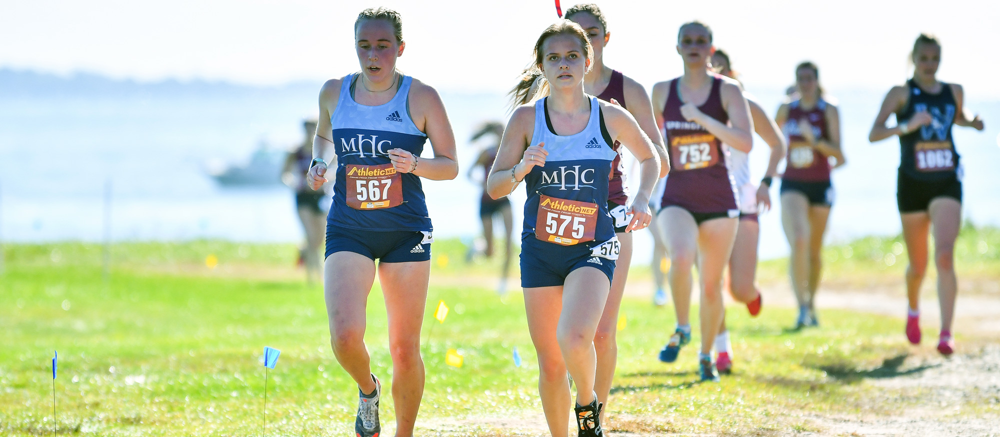 Bridget Hall (left) and Greta Trapp (center) placed 10th and 11th overall for Mount Holyoke at the season-opening Wellesley Invitational on Sept. 1, 2023. (RJB Sports file photo)